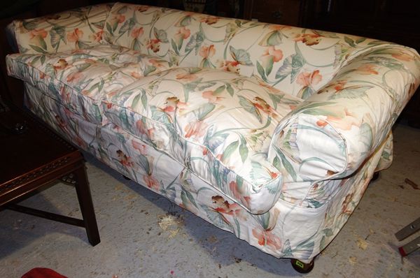 A large 20th century Chesterfield style sofa farmed from two sections with loose covers.