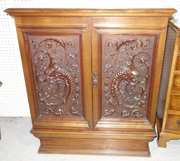 A 19th century mahogany side cabinet with profusely carved mahogany panel doors, 82cm wide