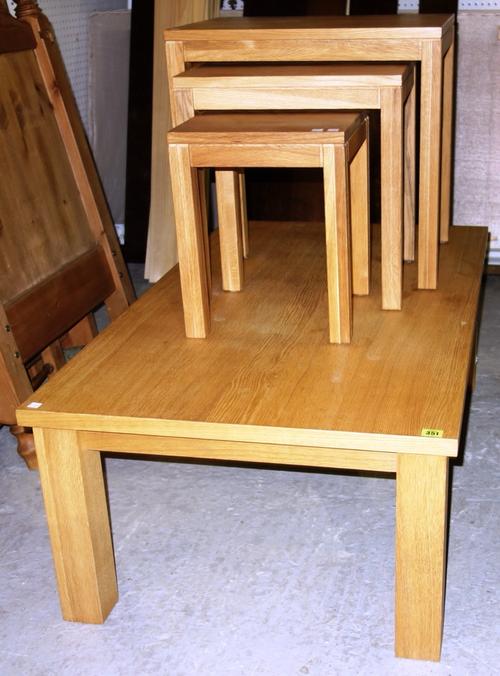 A 20th century oak coffee table, 120cm wide and a nest of three oak tables the larger 55cm wide (4)