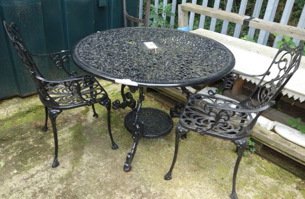 A 20th century black painted circular aluminium garden table and four chairs, (5).