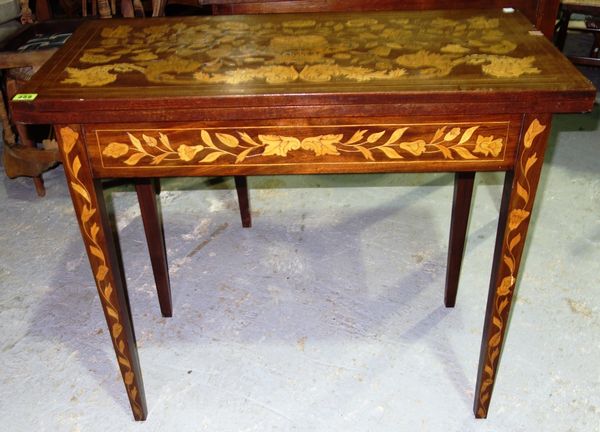 A 19th century Dutch marquetry inlaid fold over games table, 87cm wide
