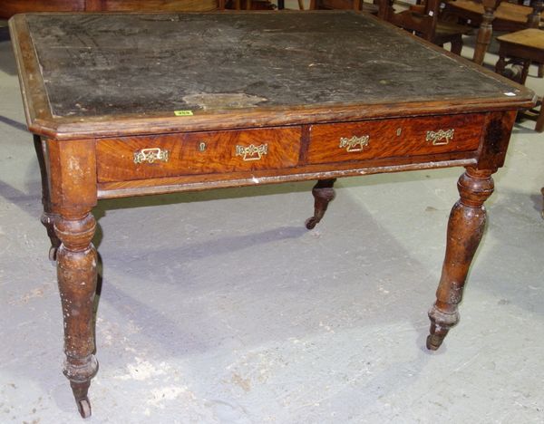 A Victorian walnut library table with two drawers and inset leather top, on turned supports,108cm wide