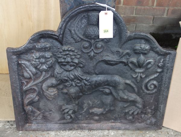 A 17th century style cast iron fireback of wealdon type and a wrought iron fire basket. (2)