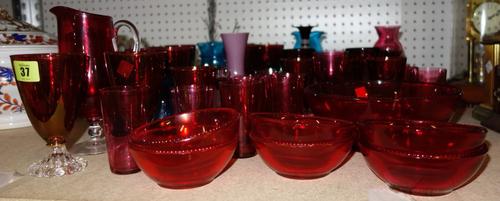 A large quantity of mainly 20th century glass ware including cranberry glass, blue glass, vases, plates and sundry. (qty)