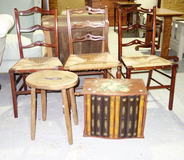 A matched set of three mahogany pierced ladderback chairs, a 19th century mahogany chair, an elm seat stool and a painted table top cabinet with simul