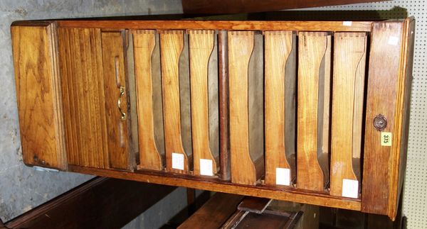 An Edwardian oak filing bank with tambour front, 46cm wide.