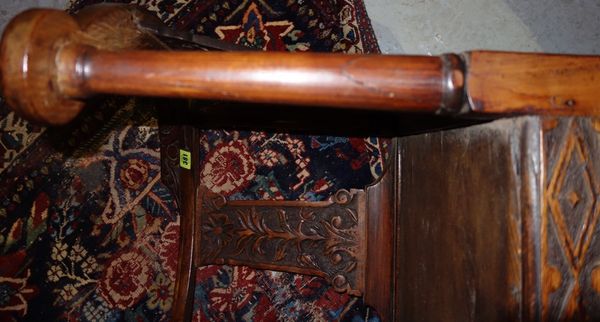 A George III and later carved elm corner chair.