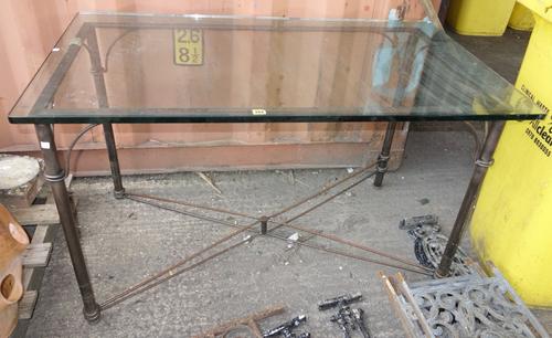 A rectangular glass top metal table.