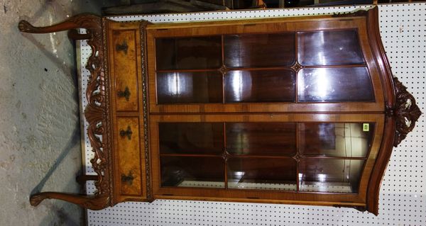 A 20th century walnut glazed bookcase, with a pair of drawers, caned decoration and cabriole supports, 85.5cm wide.