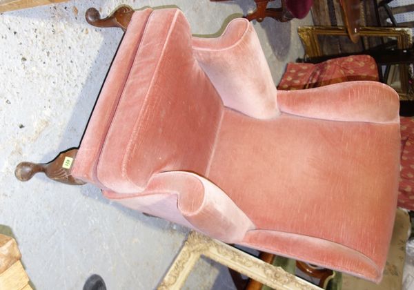 A 20th century pink upholstered wing armchair.