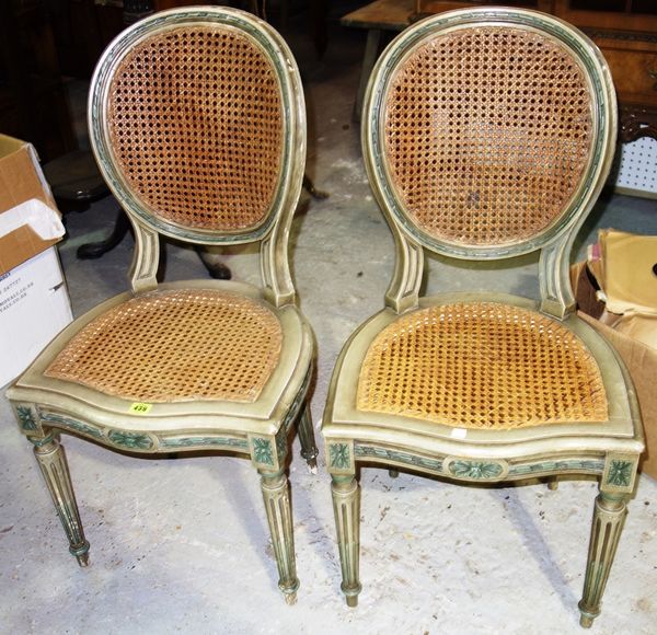 A pair of grey painted side chairs with cane backs and two chairs.