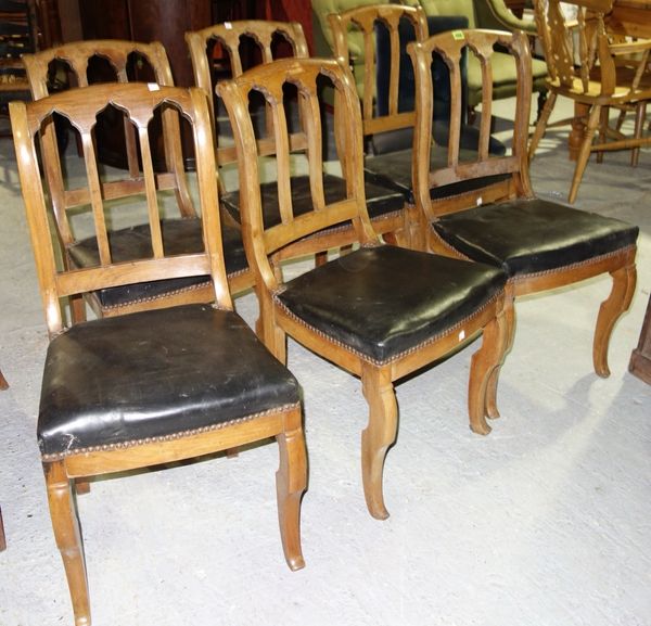 A set of six 19th century French walnut dining chairs, each with Gothic triple arch back and kick stepped cabriole legs, (a.f) (6)
