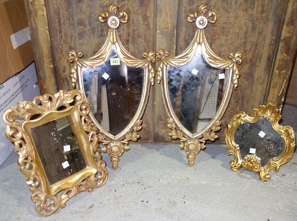 A pair of shield shape gilt mirrors and two further small gilt mirrors (4).