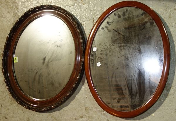 An oval mahogany wall mirror and a walnut mirror, 60 cm wide. (2)