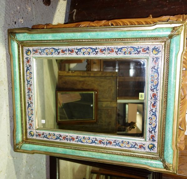 A green and gilt rectangular mirror with tile set aperture, 70 cm wide.