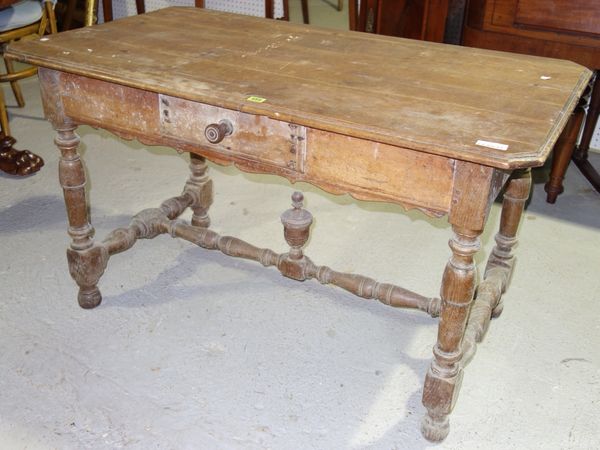 A 19th century French oak and fruitwood writing table, rectangular top with chamfered angles above single drawer on turned legs united by stretchers 1