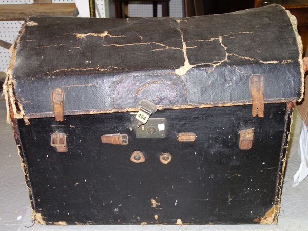 An early 20th century dome top leather trunk, 77cm wide.