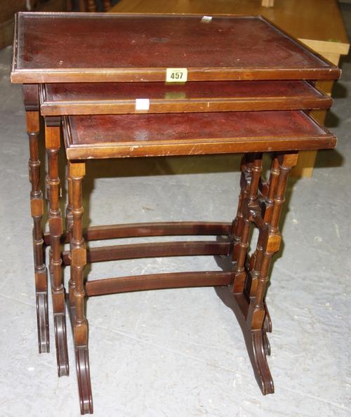 A set of three mahogany and red leather topped nesting table, the largerst 57cm wide, (3).
