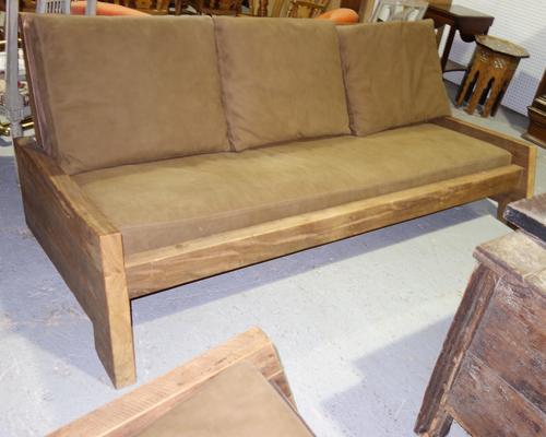 A 20th century hardwood framed three piece suite, comprising; a sofa, 220cm wide and two armchairs with rocking bases. (3)