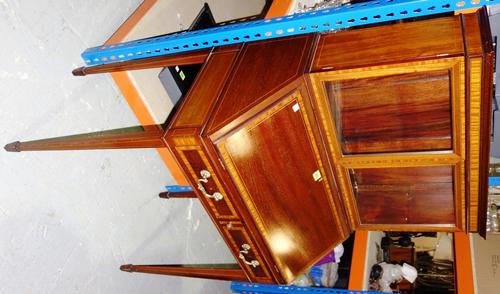An Edwardian mahogany bonheur du jour, with two glazed doors above the fall, applied label of Hewetson, Milner and Thexton Ltd London, 73cm wide.