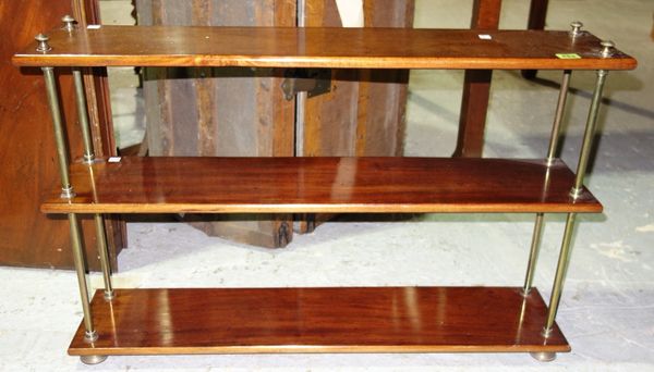A 19th century mahogany and brass three tier campaign style wall shelf, 89cm wide.
