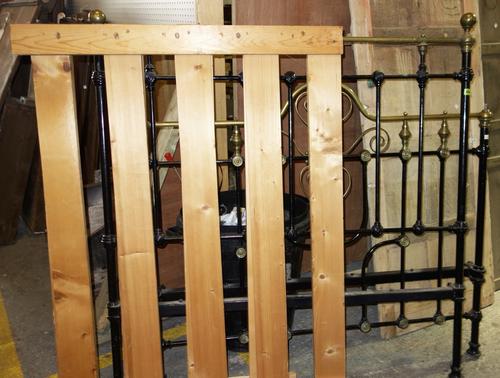 A 19th century wrought iron and brass bed.
