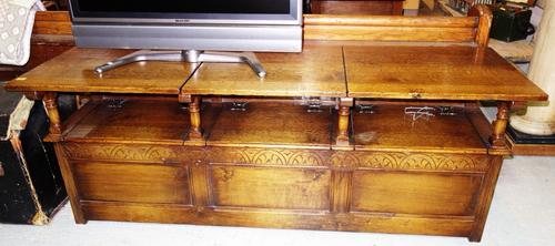 A 20th century oak triple section monk's bench, with three panel front and carved decoration, 188cm wide.