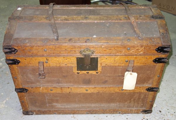 An early 20th century canvas and wooden bound domed top trunk.