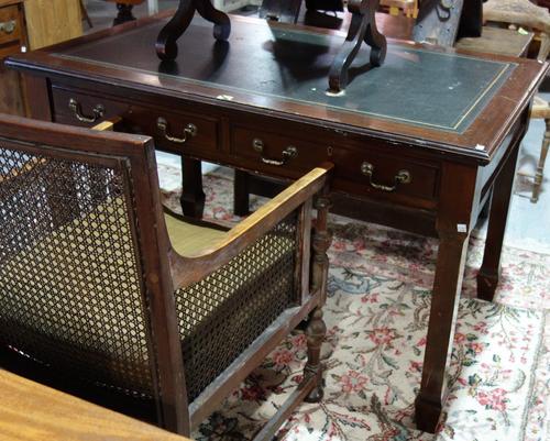 A late 19th century mahogany writing desk, with inset gilt tooled leather top over two frieze drawers, on tapering square supports, 122cm wide.