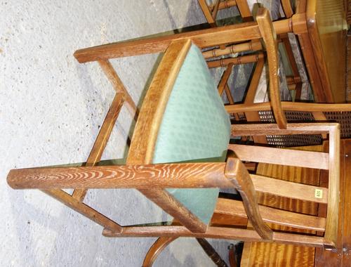 Heal's, a mid 20th century limed oak open armchair, with bow crest rail on tapering square supports, with ivorine circular disc 'Heal's Tottenham Cour