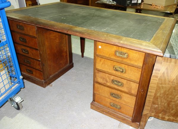 A 19th century teak framed pedestal campaign style writing desk, each pedestal with five drawers enclosed by locking bar, the reverse each with a pair
