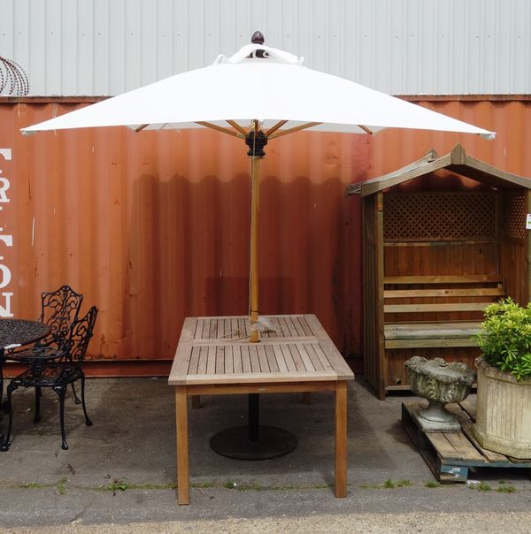 A teak garden table and parasol.
