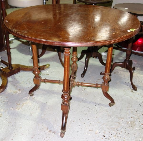 A late 19th century mahogany occasional table, the circular top on four turned supports united by 'X' frame stretcher, 76cm wide.