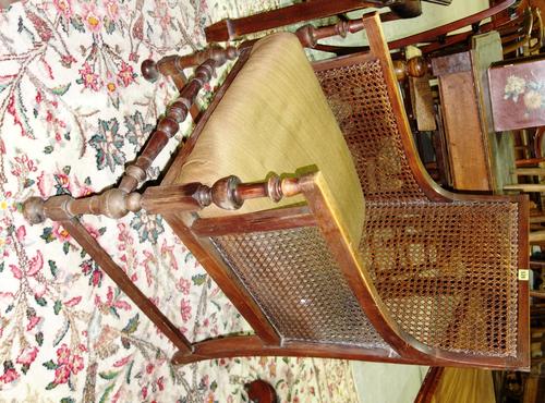 A 20th century oak and cane bergere.