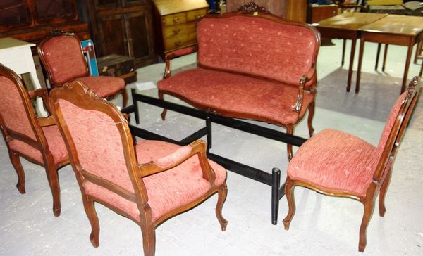 A red upholstered 20th century walnut framed salon suite comprising sofa, two open armchairs and two side chairs. (5)