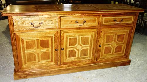 A 20th century hardwood and inlaid sideboard with three drawers and cupboards, 180cm wide.