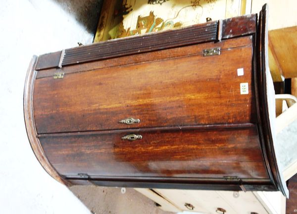 A 19th century oak bowfront corner cabinet.