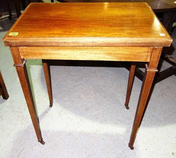 An Edwardian mahogany fold over card table.