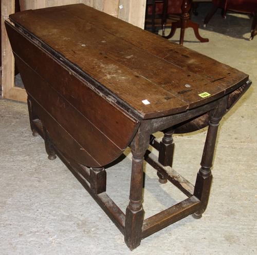 A 18th century oak drop flap dining table, 123 cm wide.