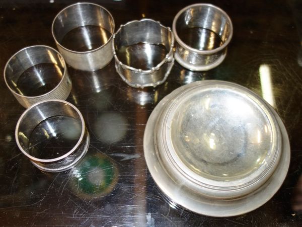 A group of six silver napkin rings and a silver dish. (7)