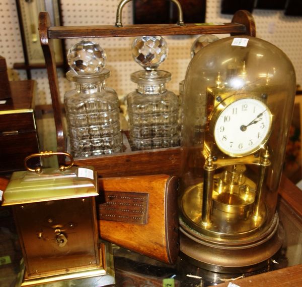 A group of collectables, including an oak three bottle tantalus, an anniversary clock, an onyx and gilt clock and a cribbage board made from a gun sto