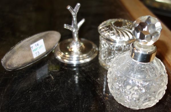 A group of silver mounted wares, comprising; an Edwardian silver ring tree with a loaded base, Birmingham 1905, a cut glass scent bottle with a silver