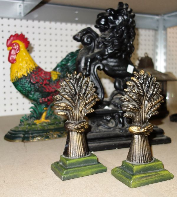 A 20th century pierced metal fire fender and a group of cast iron door stops (qty).