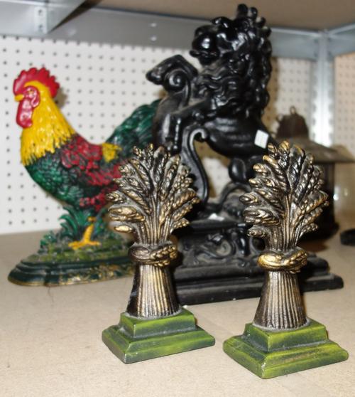 A 20th century pierced metal fire fender and a group of cast iron door stops (qty).