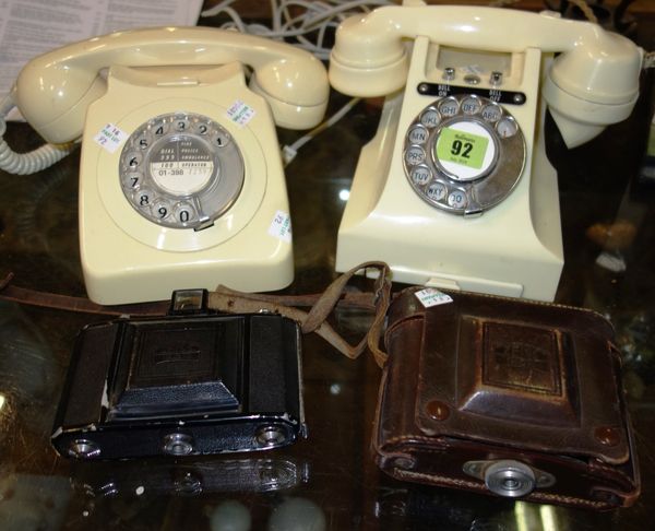 A similar pair of 20th century cream Bakelite telephones and two cameras. (4)