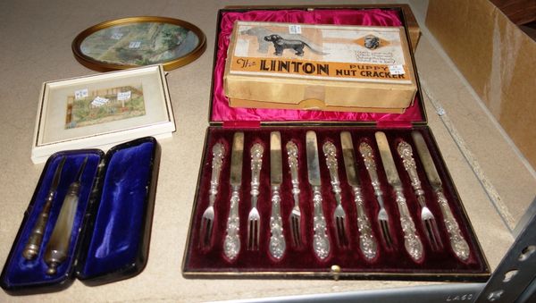 A cased set of silver handled knives and forks, a cased set of knives, one with agate handle, possibly Scottish, a nutcracker formed as a dog and sund