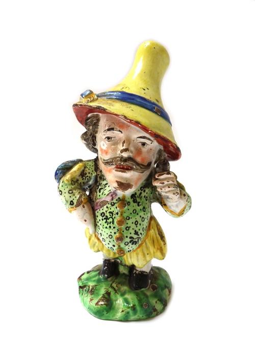 A group of six Staffordshire pearlware figures of Mansion House dwarfs, early 19th century, each colourfully dressed character standing on a grassy mo