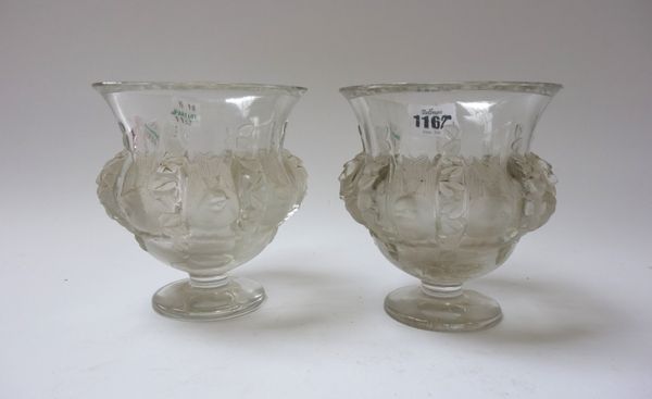 A pair of Lalique 'Dampierre' clear and frosted glass vases, post war, designed by Marc Lalique, each moulded with sparrows and vines, and raised on a