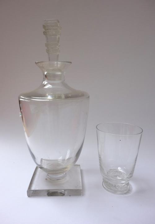 A part suite of Lalique glass wares in the 'Argos'' pattern, designed 1939, comprising; two decanters and stoppers, 27cm high, a water jug, ten rinsin