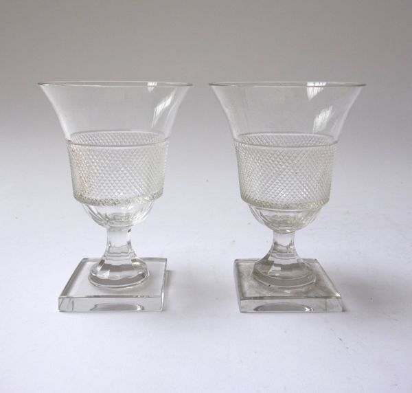 A part suite of glassware, 20th century, with hobnail cut band to the outswept bowl, raised on a square foot, comprising; four champagne glasses, 16.8